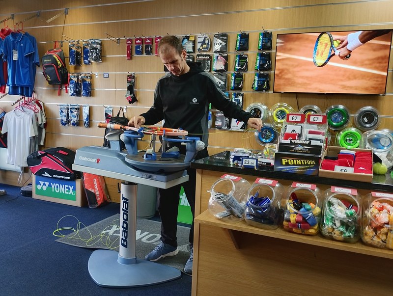 Geoff restringing a racket on the Babolat machine in his Reading shop